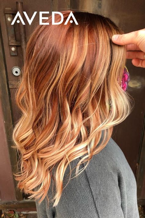 Adding a copper twist to your summer balayage is a great way to transition your hair for the fall season. These warm red and copper tones are reminiscent of our favorite colors of autumn. Click to find an Aveda Salon near you to achieve your own autumn hairstyle. Aveda Artist @shauna_planethair #CopperBalayage #FallHairColor #RedHair #WavyHair #CopperHair #MediumLengthHairstyles Dark Auburn Hair With Blonde Balayage, Red Bayalage Hair With Money Piece, Cooper Red With Blonde Highlights, Half And Half Hair Color Underneath Red, Red Hair With Blonde Balayage Ombre, Blonde Hair With Copper Highlights Low Lights, Red Hair With Blonde Highlights Money Piece, Blond Copper Highlights, Root Smudge Strawberry Blonde