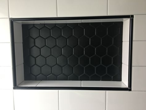 New shower niche with 2" black matte hex tiles and 4"x8" white subway tiles.  Edged with black Schluter trim. All tiles from ArtTile in Oakland, CA White Bathroom Tile Black Grout, Black Bathroom Niche, Shower Niche Black And White, Shower Trim Tile, Black Niche Bathroom, Black Schluter Tile Edge Showers, Shower Niche Trim, Black Shower Niche, Schluter Trim