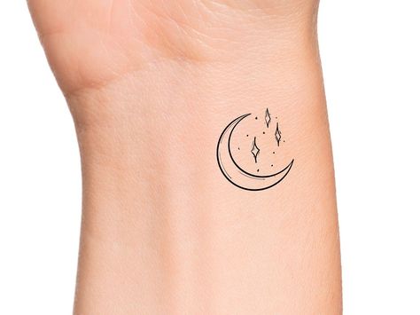 Moon Stars Temporary Tattoo Size: The size of this temporary tattoo is approximately 1 inch Directions: 1. Cut excess paper around tattoo with scissors to eliminate any unnecessary adhesive on your skin after applying. 2. Peel away the clear plastic layer. 3. Apply the tattoo image side to your skin and cover with a damp cloth for 20 seconds. 4. Carefully peel back paper off of your skin and allow the tattoo to dry for at least 10 seconds. Do not touch it. 5. After allowing for dry time, your ta Tattoo Star And Moon, Black Crow Tattoos, Heart Temporary Tattoos, Petit Tattoo, Mom Tattoo Designs, Crow Tattoo, Temp Tattoo, Mother Daughter Tattoos, Wrist Tattoo