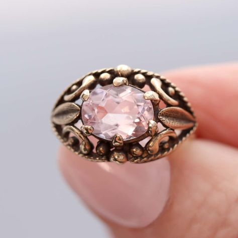 A sensuous Late Victorian gold ring is set with an oval Morganite. The petal-pink Morganite Beryl(a new addition to the ring) weighs 1.73 cts and is set "east-west" atop the open work dome of this lovely ring. The contours of the ring has it fitting as 4.75. Resizing may be possible, please inquire. The ring is an antique original from the early 20th Century. 10K gold. Stamped with the maker's mark "JA". #leighjayandco #antiquejewelry #antiquejewelryforsale #artdecojewelry  #antiquejewelryad... Victorian Gold Ring, Antique Locket, Jewelry Ads, Vintage Wedding Band, Victorian Gold, Pink Morganite, Retro Jewelry, Antique Necklace, Lovely Ring