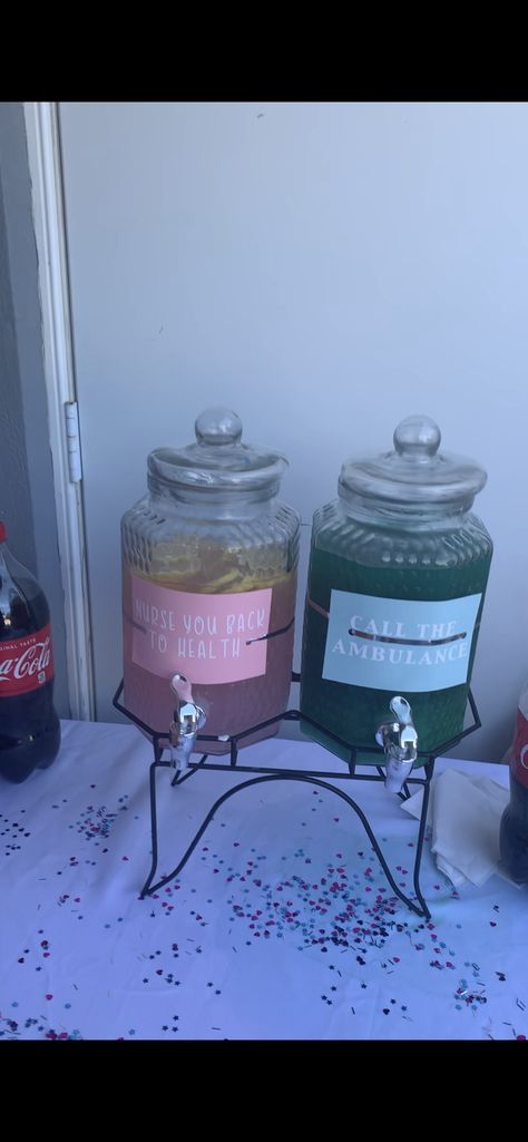 Cute drink names for Nurse or firefighter Gender Reveal Party.   If you try this-  the pink is Minute Maid pink lemonade and Tito’s vodka.   The “boy” is Tito’s, pine apple juice and Blue Curaçao Liquor. I only used one bottle and had to had a lot more pineapple juice cause I went over on the Tito’s. When you do it buy TWO bottles of blue curaçao and it will be more blue rather than greenish. Badges And Bows Gender Reveal, Firefighter Gender Reveal Party, Firefighter Gender Reveal Ideas, Firefighter Gender Reveal, Minute Maid Pink Lemonade, Gender Reveal Drinks, Pine Apple, Drink Names, Bow Gender Reveal