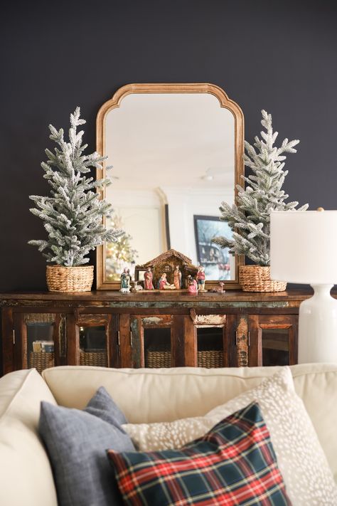 I LOVE this simple Christmas decor in our living room. Wooden Framed mirror, flocked tabletop Christmas trees and my nativity set. Traditional Christmas Living Room, Wooden Framed Mirror, Tabletop Christmas Trees, Simple Nativity, Decor Ideas For Living Room, Navy Walls, Christmas Living Room, Winter Decorations, Simple Christmas Decor