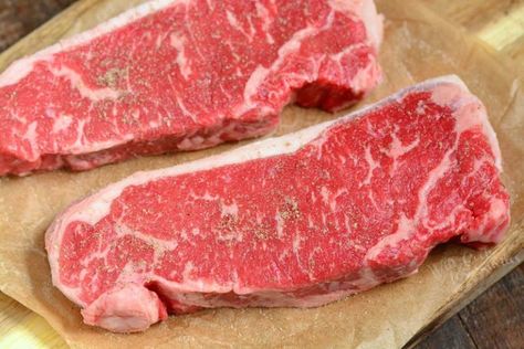 raw strip steaks on parchment paper Strip Loin Steak Recipes, Loin Steak Recipes, Strip Loin Steak, Cook Steak In The Oven, Pork Loin Recipes Oven, Oven Steak, Steak In The Oven, Cooking The Best Steak, Cast Iron Steak