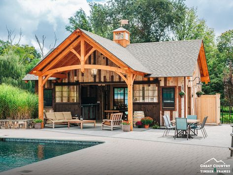 Take a look at this 20' x 32' Montauk Pool House, raised in Rhode Island. Eastern white pine makes the frame of this pool house, with a brown blend of reclaimed barn board around the exterior. A timber frame truss adorns the entryway, and sliding barn doors open to lead inside. #greatcountrytimberframes #timberframe #postandbeam #barnbuilders #timberframing #mortiseandtenon #joinery #keepcraftalive #timberframer #poolhouse #luxury #montauk #pool #poolside #barnboard #easternwhitepine #tby9453 Barn Apartment Plans, Accordion Glass Doors, Barn Pool House, Victorian Pool, Barn Pool, House Columns, Home Basketball Court, Timber Frame Joinery, Timber Frame Design