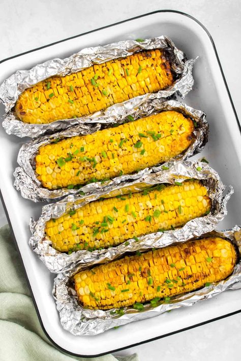 Grilled corn on the cob in foil is a summer staple! It's one of the easiest and tastiest ways to enjoy corn without a ton of effort. Get perfectly cooked grilled corn every time with this simple guide on how to grill corn. Corn On Grill In Foil, How Long To Grill Corn On The Cob, Grilling Corn On The Cob Without Husk, Grill Corn On The Cob In Foil, Grill Corn On The Cob In Husk, Corn On Cob On Grill, Grilled Corn On The Cob In Husk, How To Grill Corn On The Cob, Corn On The Cob On The Grill