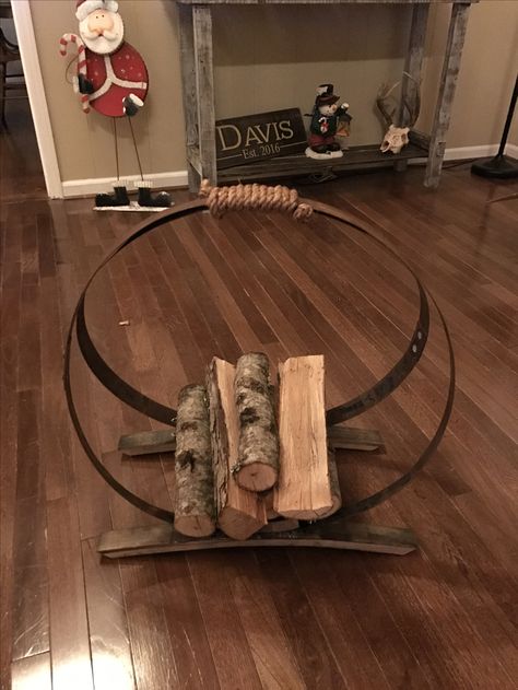 Firewood rack made with barrel rings and staves Barrel Ring Art, Wine Barrel Diy, Wine Barrel Art, Wine Barrel Decor, Wine Barrel Crafts, Barrels Diy, Wine Barrel Rings, Whiskey Barrel Furniture, Barrel Projects