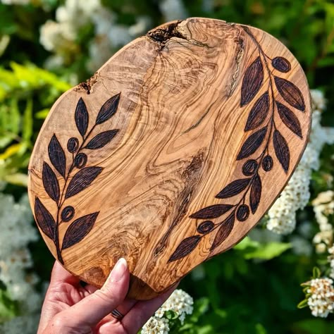 All of woods serving board with beautiful grain simple olive leaf design wood burned around the edges Olive Wood Pyrography, Wood Burning Charcuterie Board, Simple Wood Burning Patterns, Olive Branch Art, Wood Tattoo, Pyrography Designs, Wood Burning Patterns Stencil, Wood Charcuterie Board, Wood Burn Designs