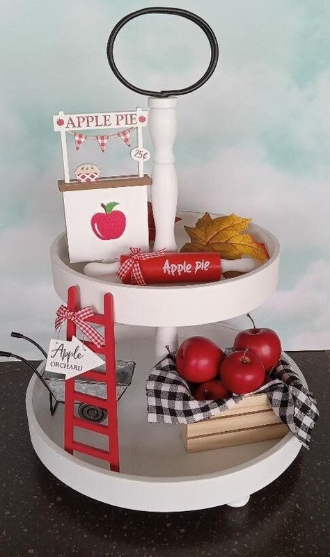 "READY TO SHIP This adorable Apple themed Tired Tray Decorations are ready to make your home stand out this Autumn season! Perfect accent to your tired tray, coffee bar, or as a cute shelf sitter. Each Item sold separately : Choose item at drop-down box. **Each item measures approx.: ~ Apple Pie stand: 6 tall x 3.5 wide x 0.75- inch ~ Rolling pin 7\" long ~ Ladder Each 8\" tall ~ Silver Wheel Barrow:  6\" long x 2.5\" wide x 2.5 tall ~ Apple Crate with 5x red apples and checkered (removable) 4\" tall x 5\" long x 3.5\" deep (Please keep in mind the exact measurements will vary)  Indoor display only. decorative purposes only **PLEASE KEEP OUT OF REACH FROM CHILDREN AND PETS** ~~DO NOT EAT~~ -Color may vary due to lighting/monitor/device screen. I carefully package each item in a box with ca Fall Apple Decor, Tired Tray Decor, Pie Stand, Cute Shelf, Apple Crate, Cottage Kitchen Decor, Apple Decor, Apple Wreath, Diy Apple