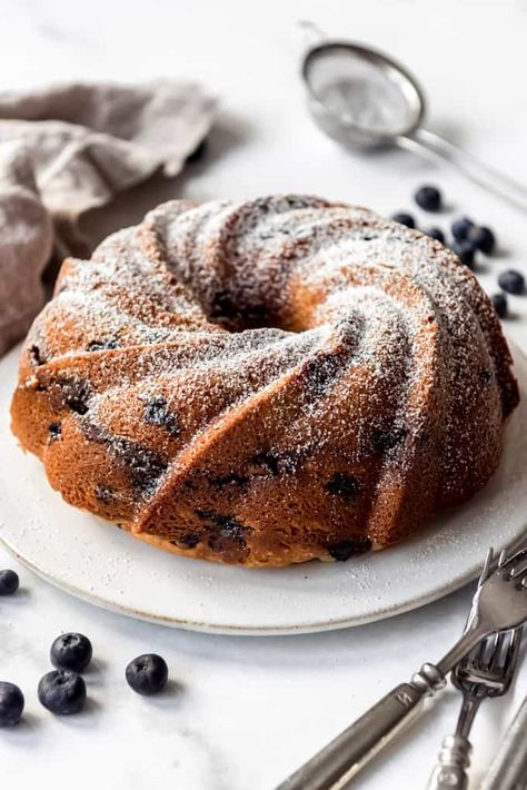 This moist Blueberry Sour Cream Coffee Cake is loaded with sweet blueberries, has a crumbly, cinnamon, streusel center, and is baked to perfection. All you need is a little dusting of powdered sugar for a wonderfully delicious breakfast, dessert, or afternoon treat! #blueberries #sourcream #coffeecake #bundtcake #bundt #best #dessert #fresh #frozen #cake #breakfast Pie With Pudding, Blueberry Sour Cream Coffee Cake, Blueberry Bundt Cake Recipes, Pound Cakes Recipes, Orange Muffin Recipe, Curd Cake, Blueberry Bundt, Blueberry Buttermilk Pancakes, Blueberry Bundt Cake