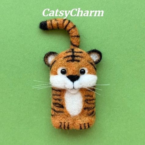 Needle felted wildlife animals.  This wool-felted tiger can be a magnet, pin or brooch.  Design and handmade by CatsyCharm. Needle Felted Tiger, Felt Needling, Cute Wildlife, Brooch Design, Felted Animals, Tiger Face, Felt Food, Needle Felted Animals, Wildlife Animals