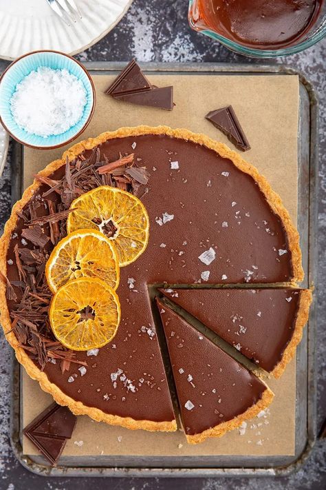 Chocolate-Orange Tart | Rich, chocolatey ganache tart w/ a hint of orange. Perfectly balanced w/ flaky sea salt & crumbly sweet tart crust. Elegant & scrumptious dessert for any holiday party! #chocolate #ganache #orange #baking #tart #seasalt #dessert #dessertrecipe #holidayrecipe #dinnerparty #christmas #partyrecipe | The Missing Lokness Brze Torte, Chocolate And Orange Tart, Candied Orange Slices, Patisserie Fine, Candied Orange, Tarts Crust, Chocolate Tart, Chocolate Shavings, Chocolate Orange