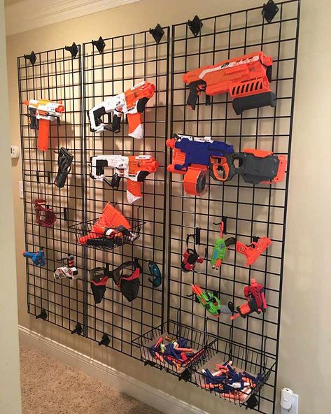 Video Game Room Decor Diy, Nerf Fun Wall, Storage For Big Toy Trucks, Playroom Ideas With Tv, Nerf Armory Wall, Nerf Wall Boy Rooms, Nerf Bedroom Ideas, Nerf Room Ideas Boys, Nerf Wall Storage