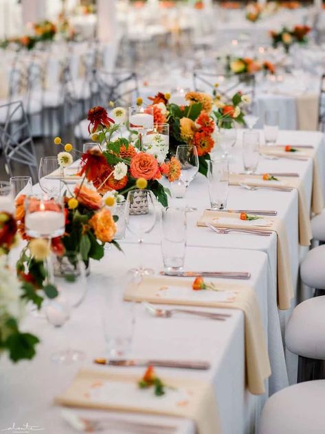 Long rectangle reception tables lined with vibrant orange summer flowers in low vases. Rectangular Flower Arrangements Long Tables, Low Centerpieces Wedding Long Table, Rectangle Table Centerpieces Wedding, Orange Summer Wedding, Square Wedding Tables, Summer Wedding Flowers Centerpieces, Summer Wedding Floral, Centrepiece Ideas, Chihuly Garden