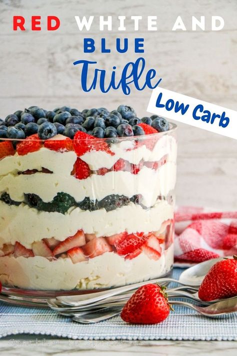 red white and blue trifle in a bowl with a few spoons and strawberries laying next to the bowl Berry Truffle Dessert Easy, Red White And Blue Triffle Desserts, Patriotic Trifle Dessert, Berry Truffle Dessert, Healthy Patriotic Desserts, Low Carb 4th Of July Food, Low Sugar Summer Desserts, Keto 4th Of July Desserts, Keto Trifle Desserts