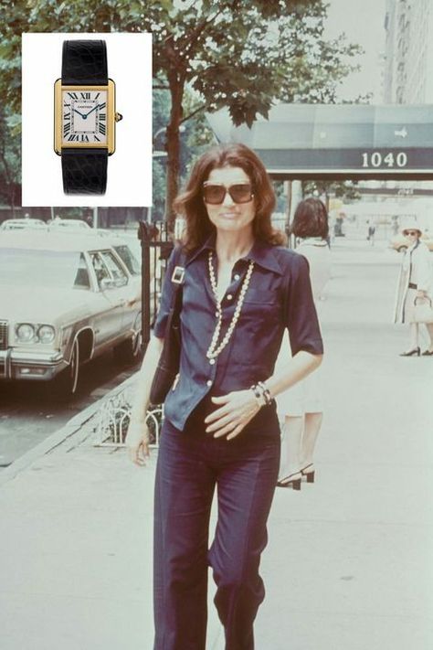 Jackie received a gold Cartier tank watch with a black band from her brother-in-law Stanislas Radziwill in 1963, and it soon became one of her favorite pieces. She sported the timeless watch for decades (it can be spotted on her wrist in this picture), and Cartier still sells a version of the style today. Jackie O Style, Jackie Onassis, Carla Bruni, Auburn University, Retro Mode, Jackie O, Costume Intero, Lady Diana, Cara Delevingne