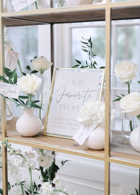 Escort Cards Displayed on Glass and Gold Shelf with Bud Vases | Moonlight Iris | South Carolina Society Hall Wedding | Downtown Charleston Wedding | Historic Charleston Downtown Building Wedding | Winter Wedding | All White Wedding | Cushla Beasley Photography | Absolute Wedding Perfection Wedding Shelf Display, Wedding All White, Charleston Downtown, Gold Shelf, Gold Shelves, Vase Display, All White Wedding, Downtown Charleston, Card Display