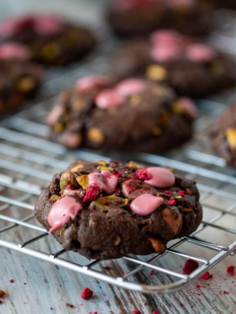 These ruby chocolate chip cookies have ruby chocolate, pistachios and dried raspberries combined in a chocolate cookie base! They have a soft center and crisp edges for a delicate fruity flavor that is out of this world!. Try some ruby chocolate today for a new and different twist on classic chocolate chip cookies. Ruby Chocolate Cookies, Heath Bar Cookies, Classic Christmas Cookies, Italian Ricotta Cookies, Ruby Chocolate, Chocolate Christmas Cookies, Cookie Base, Pistachio Cookies, Ruby Tuesday