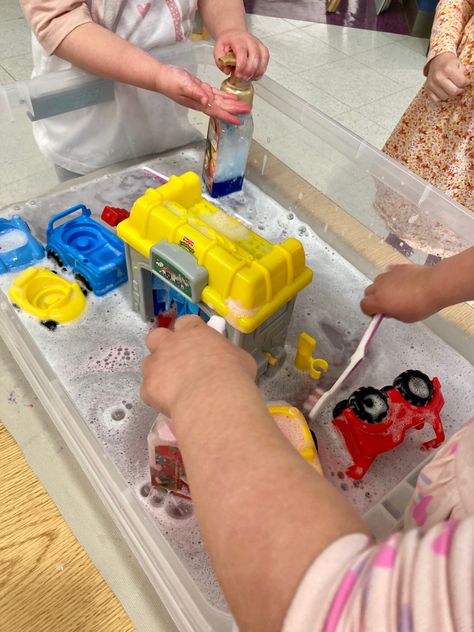 Washing cars has never been more fun! Some water, and recycled foam soap pumps with dish soap, and a couple of toothbrushes make a great car wash for our toy cars. We have a Fisher Price car wash that we like to put in the bin, too. This provided all morning entertainment forour class of three year olds! Diy Car Wash For Kids, Car Wash Sensory Bin, Car Wash Station, Outdoor Eyfs, Diy Car Wash, Preschool Transportation, Transportation Theme Preschool, Toddler Sensory Bins, Transportation Preschool