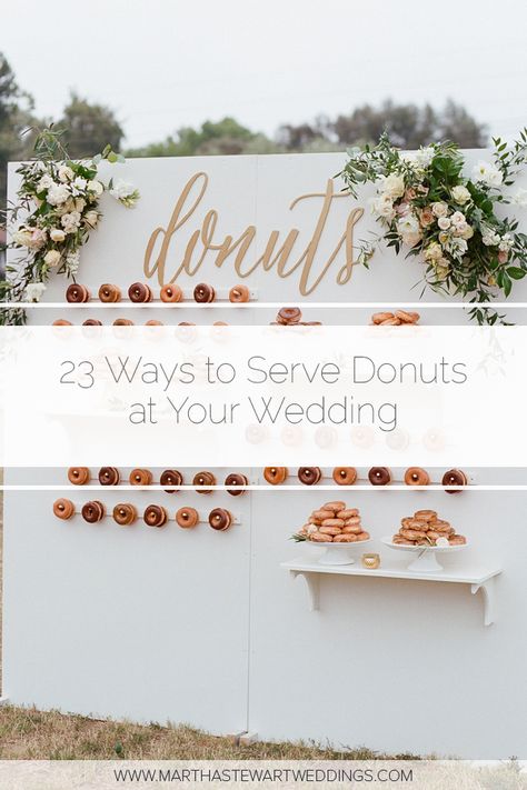 23 Ways to Serve Donuts at Your Wedding That Your Guests Will Love! These fun reception desserts are a creative alternative to classic wedding cake. #WeddingIdeas #WeddingFood #WddingDonuts #FunWeddingFood | Martha Stewart Weddings - 23 Delicious Ways to Serve Donuts at Your Wedding Donut Wall For Wedding Reception, Donuts Wall Wedding, Doughnut Dessert Table Wedding, Donut Reception Ideas, Donuts Instead Of Wedding Cake, Displaying Donuts Party Ideas, Doughnut Table Ideas, Wedding Donut Bar Dessert Tables, Doughnut Wedding Cakes