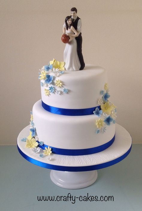 2 tier Wedding Cake basketball topper with royal blue & yellow flowers Wedding Cake Basketball, Wedding Cake Designs 2 Tier Blue, Simple Wedding Cake Blue And White, Royal Blue Wedding Cake 2 Tier, 2 Tier Wedding Cakes Simple Elegant Blue, Wedding Cake Designs Simple 2 Tier, Lobola Cakes, Blue Wedding Cake Designs, Blue And Yellow Wedding Cake