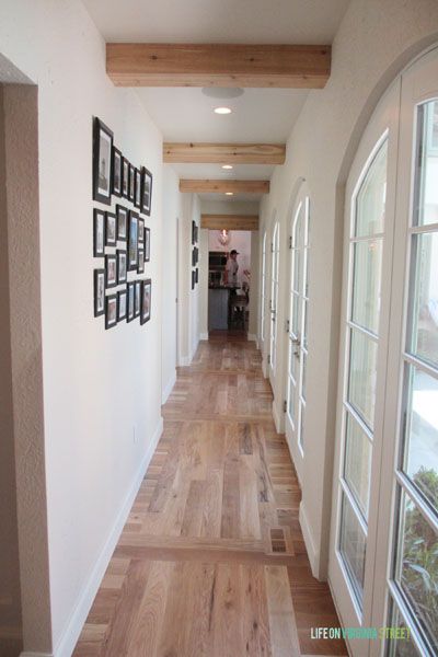 Gorgeous hallway with wood floors, french doors and exposed wood beams. Exposed Wood Beams, Wood Floor Pattern, Hallway Ceiling, Hotel Design Architecture, Life On Virginia Street, Faux Wood Beams, Faux Beams, Wood Beam, Hallway Designs