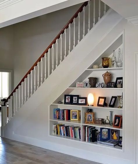 An open storage under built into the staircase is a cool bookcase that doesn't require any floor space Shelves Under Stairs, Under Stairs Storage Solutions, Closet Under Stairs, Staircase Styles, Recessed Shelves, Home Engineering, Staircase Storage, Bungalow Exterior, Stair Case