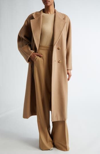 Expertly hand-stitched in the softest virgin-wool-and-cashmere blend, this long coat is a classic with a straight silhouette cinched by a waist-defining belt. 48" length (size 8) Double-breasted button closure Notched lapels Front welt pockets Removable tie belt Lined 90% virgin wool, 10% cashmere Dry clean Made in Italy Designer Clothing Luxury Oversized Single-breasted Wool Coat, Reiss Mia Coat, Zara Belted Wool Blend Coat, Camel Coat Uk, Quiet Luxury Fashion Fall 2024, Max Mara Coat Street Style, Tan Long Coat, Ceo Fashion, Elegant Capsule Wardrobe