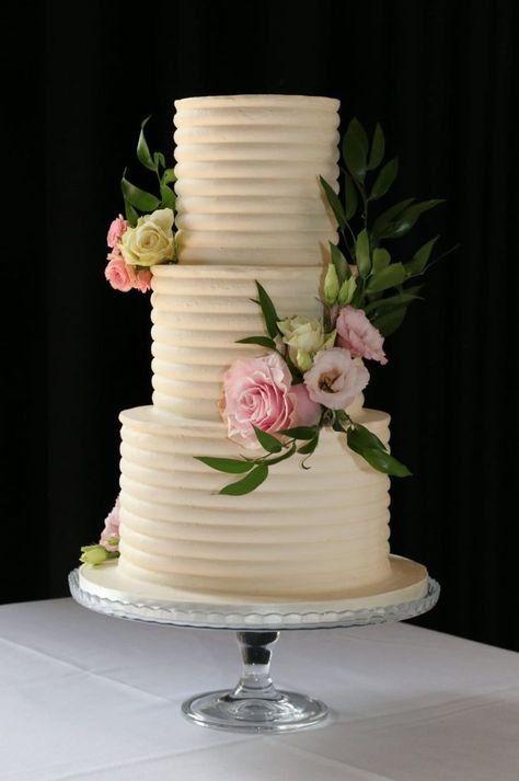 3-tier ribbed wedding cake with pink flowers Simple Elegant Wedding Cakes 3 Tier, Ribbed Wedding Cake, Simple 3 Tier Wedding Cake, 3 Tier Wedding Cake Elegant, Simple Wedding Cake 3 Tier Fresh Flowers, 3 Tier Textured Wedding Cake, Plain White 3 Tier Wedding Cake, Rosette Wedding Cake 2 Tier, Couple Wedding Invitation