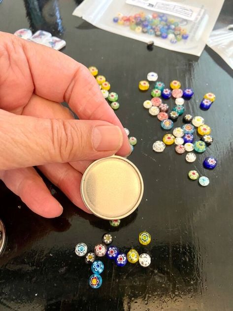 I had these beautiful tiny millefiori glass patterned beads but wanted to somehow make them into a pendant style necklace. I was Inspired after seeing someone else’s version of resin jewellery making online it looked easy and so I decided to have a go myself. Here’s how I did it. I used a silver metal pendant blank that would allow me to place my beads into the base and build my own design. These are easily available to buy online and come in many styles and colours. I squeeze the… Glass Necklaces With Tiny Beads For Jewelry Making, Adjustable Murano Glass Necklaces With Round Beads, Millefiori Necklace Aesthetic, Round Polished Murano Glass Beaded Necklace, Millefiori Glass Jewelry, Resin Pour, Resin Jewelry Making, Pretty Pendant, Resin Pendant