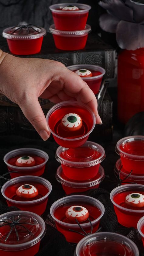 These Halloween eyeball jello shots are fun and easy to make. They're sure to be popular at your Halloween party and everyone is going to want one, or even a matching pair! Dial up the creepy factor by making some Halloween themed food and drinks. You only need 4 ingredients to make these - jello powder, boiling water, berry vodka, and candy eyeballs. You can make them ahead and just keep them in the refrigerator until the party is underway and it's time to serve up these ghoulish jello shots! Spooky Jello Shots, Spooky Jello, Eyeball Jello Shots, Eyeball Jello, Syringe Jello Shots, Shots To Make, Vodka Water, Halloween Jello Shots, Halloween Jello