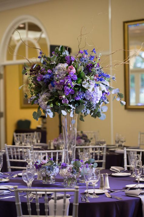 Purple Wedding Reception Table Decor | Silver Chiavari Chairs and Purple and Ivory Tall Table Floral Centerpieces Purple Table Cloth Wedding, Purple And Silver Wedding Centerpieces, Tall Purple Centerpieces, Purple And Blue Centerpieces, Blue Purple And Silver Wedding, Purple And Blue Decorations, Purple Table Settings Wedding, Purple Wedding Reception Tables, Lavender Wedding Centerpieces