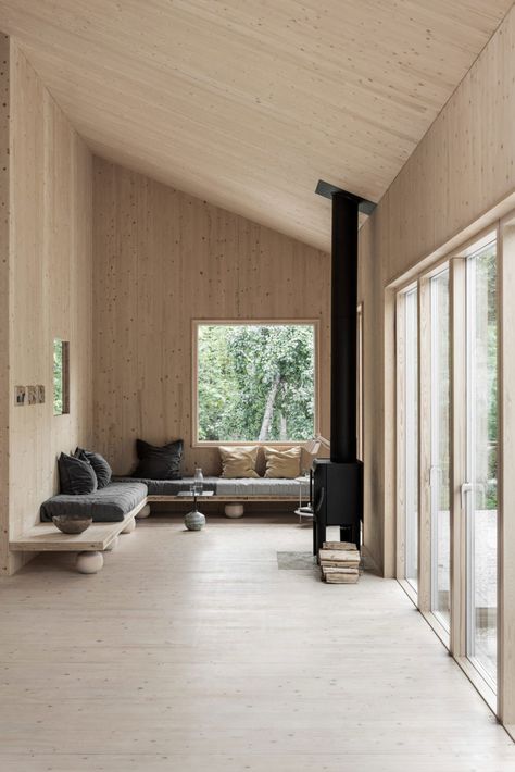 Peek Inside a Minimal Getaway in Sweden | a warm wood interior with wood clad walls, ceiling and floor, a wrap around sofa and black wood burner #nordicinterior #woodcabin #scandinavianstyle Scandinavian Cabins, Contemporary Cabin, Interior Boho, Cabin Interiors, Nordic Interior, Modern Cabin, Wood Interiors, Cabin Design, Nordic Design