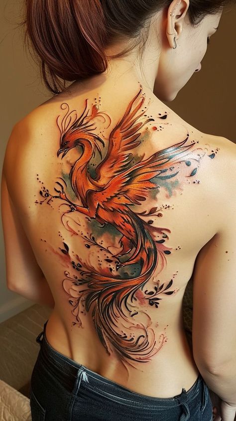 Phoenix tattoo design on woman's back featuring vibrant colors and intricate details, symbolizing rebirth and transformation. Free Bird Tattoo, Phoenix Back Tattoo, Rebirth Tattoo, Phoenix Bird Tattoos, Phönix Tattoo, Woman's Back, Phoenix Tattoo Design, Tattoos For Women Flowers, Spiritual Tattoos