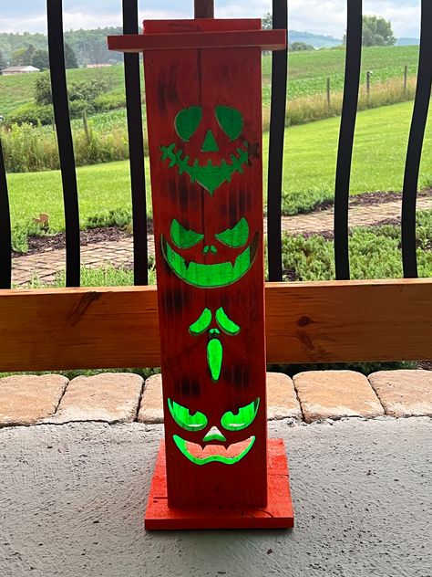 Hand made all wood stacked jack-o-lanterns and totems.  Available in small medium and large sizes. Remote controlled multi-function LED lights are included.  These are made from pressure treated lumber with waterproof LED lights for years of use.  Available in unfinished, black, or orange finishes.   Small is approximately 12-16 inches tall with 1 face and "Boo" carved on the right and left sides.  Medium is approximately 18-22 inches tall with 2 faces and "Spooky" carved on the right and left sides. A mirror finish is applied to the inside of the top to improve glow from the LEDs. Large is approximately 24-28 inches tall with 4 faces and "Trick or Treat" carved on the right and left sides. A mirror finish is applied to the inside of the top to improve glow of LEDs. Each comes with it's ow Wood Scroll Saw Projects, Diy Wood Holiday Decor, Halloween Wood Crafts To Sell, Halloween Wooden Decorations, Wood Pumpkin Lanterns Diy, Woodwork Halloween, Pallet Wood Halloween Decorations, Wood Jack O Lantern Diy, Halloween Wood Projects