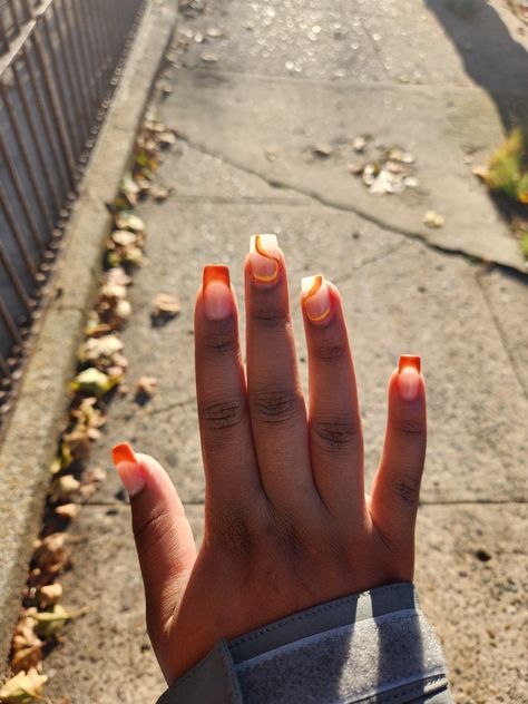 Medium/short length square acrylics. Burnt orange french tips with and yellow and orange swirl designs Medium Length Orange Nails, Burnt Orange Short Nails, Burnt Orange French Tip Nails, French Tip Orange, Orange Swirl Nails, Orange French Tips, Square Acrylics, Burnt Orange Nails, Orange Acrylic Nails