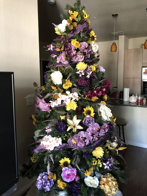 A work in progress. Christmas tree with orchids, lilies, hydrangeas, sunflowers, and a myriad of other flowers and leaves Orchid Christmas Tree, Hibiscus Christmas Tree, Orchid On Tree Trunk, Disney Inpsited Xmas Treee, Bee Orchid Flower, A Work In Progress, Flowers And Leaves, Work In Progress, Hydrangea