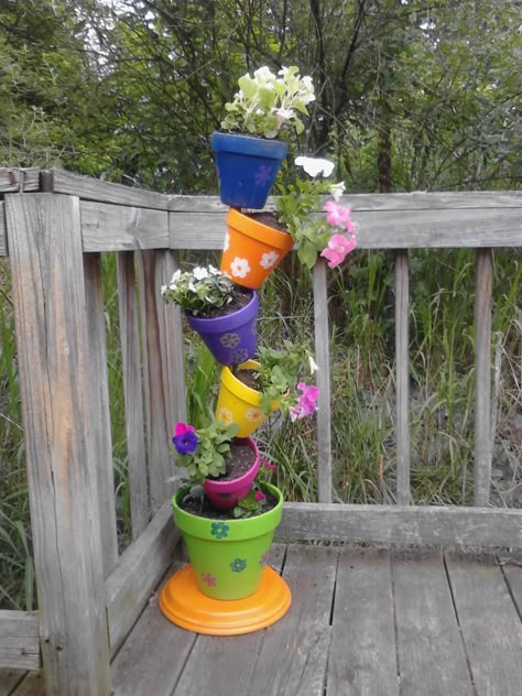 The boys and I made this for my Mother in Law :)   SO cute we came home and made another one for us! Topsy Turvy Planter, Plant Tower, Clay Pot Projects, Diy Flores, Terra Cotta Pot Crafts, Flower Tower, Flower Pot Crafts, Diy Flower Pots, Topsy Turvy