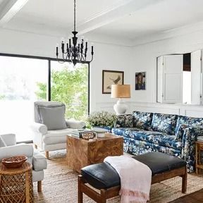 The ‘After’ Photos of This Colonial Fixer-Upper Are Jaw-Dropping Lighted Artwork, Painting Paneling, Wood Panneling, Burled Wood Table, Floral Couch, Burled Wood Coffee Table, Burled Wood Furniture, All White Room, Sofa Design Wood