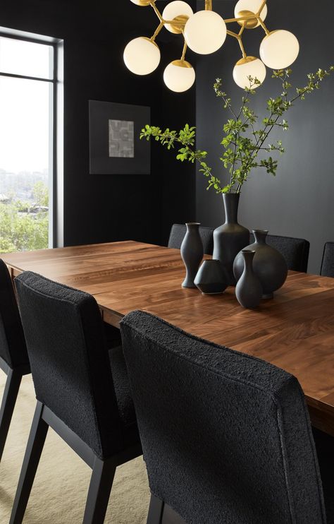 Dining room with Adams extension table, Ansel side chairs and Cosma chandelier. Dark Moody Dining Room, Moody Dining Room Ideas, Midcentury Modern Dining Room, Moody Dining Room, Dark Dining Room, Dining Room Decor Ideas, Christmas Dining Table Decor, Brown Dining Table, Wood Dining Room Table