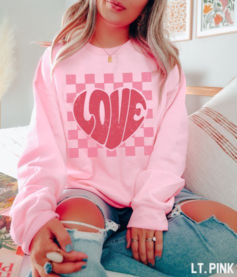 This retro-inspired Valentines Day sweatshirt is exactly what you need to express your love to your special someone! Featuring a unique and eye-catching graphic of an vintage-style love with a retro checkered background, this Valentines Day sweatshirt is sure to spark some conversation and turn heads. The soft and comfortable fabric of this sweatshirt is perfect for those chilly Valentines Day dates. Plus, the lightweight material ensures you'll be comfortable no matter how long the night takes Retro Valentines Day, Valentines Sweatshirt, Valentines Outfit, Valentines Day Sweatshirt, Love Sweatshirt, Valentines Day Date, Valentines Day Love, Sweatshirt Trendy, Cute Valentines