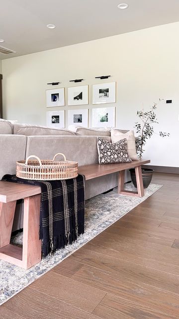 Elisabeth Yeary | organic modern | on Instagram: "Reasons I love a bench over the traditional console table behind the couch: ▫️provides additional seating ▫️it’s perfect for open concept homes ▫️the low profile makes your space feel more open. ▫️gives your guests somewhere to leave their bag . . . . . #naturaldecor #ltkhome #ltkstyletip #neutraldecor #behindthesofa #homestyling #openconcept #benchstyling" Bench Seating Family Room, Couch Placement Ideas Open Concept, Behind The Couch Bench Decor, Console Table Sectional, Back Of Couch Bench, Living Room Table Behind Couch, Kitchen Table Behind Couch, Wooden Bench Behind Sofa, Wood Bench Behind Sofa