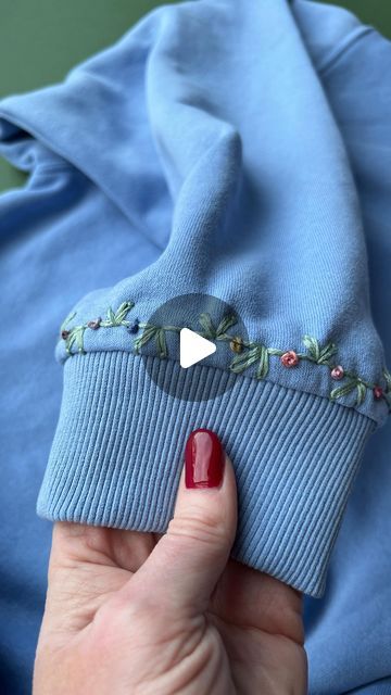 Jenny ~ Embroidery Art, Design & Crafts on Instagram: "I just love these little cuff details! What do you think? 💙 . . #upcycledclothing #upcycledfashion #knitwear #embroideredclothing #embroidereddenim #embroideredclothes #embroideredflorals #learntoembroider #mindfulart #slowstitching #sewingproject #embroiderypatterns #bordadolivre #createdtocreate #diycrafts #slowcraft #dmcthreads #dmcembroidery #springflowers #embroiderydesign #beginnerembroidery #embroiderywork #denimembroidery #sustainablefashion #embroiderhappyhoops #embroiderytutorial #embroideryprocess #embroideryproject #handsew" Embroidery On Sweatpants, Hand Embroidery On Clothes, Hand Embroidered Sweatshirt, Embroidery Clothes, Embroidery Pants, Learning To Embroider, Denim Embroidery, Embroidery On Clothes, December 16