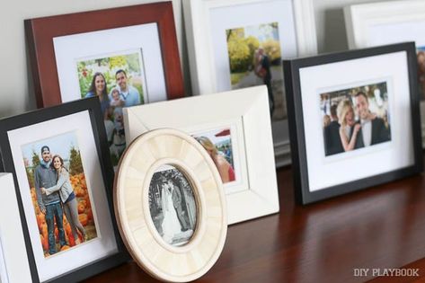 It's time to stop hiding memories behind other memories Picture Frame Table, Diy Playbook, Photo Wall Gallery, Picture Ledge, Picture Frame Display, Table Display, Decorating With Pictures, Mantel Decorations, Small Frame