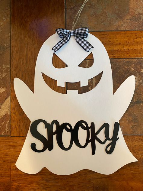 Made from Dollar Tree materials. Painted the ghost w/white acrylic paint, & the spooky sign is metal that was painted w/black spray paint. The bow was from a RD birdhouse. Dollar Tree Wooden Ghost Diy, Dollar Tree Ghost Sign, Dollar Tree Wood Ghost Crafts, Dollar Tree Ghost Wood Cutout, Wooden Ghost Painting Ideas, Wood Ghost Painting, Ghost Wood Painting, Wooden Halloween Signs, Diy Halloween Ghosts