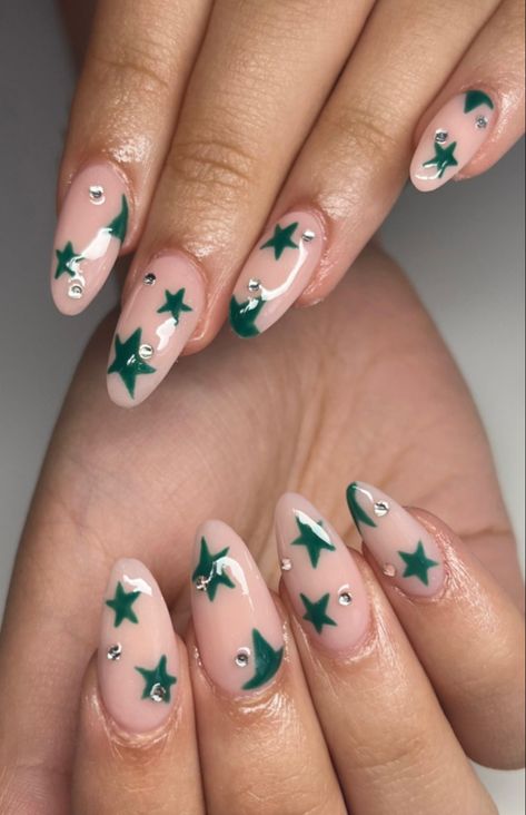 acrylic nails (pink/nude base) with green miss match stars and small dominates Green Almond Acrylic Nails Designs, Sage Green Nails With Stars, Green Star Nails Acrylic, Green And White Star Nails, Sage Green Star Nails, Dark Green Star Nails, Green Stars Nails, Green Nails With Pearls, Green Nails With Stars