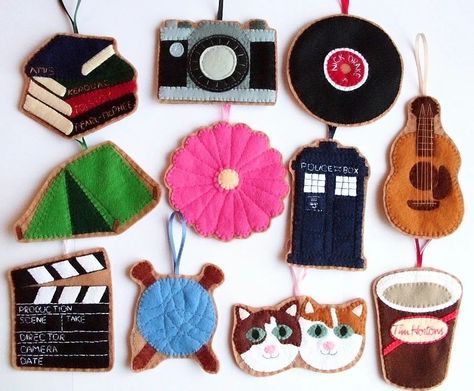 Here's a closer look at those custom felt ornaments I shared a snap of the other day! These were a wedding gift, with each ornament depicting one of the couple's hobbies or favourite things. A stack of books with beloved authors embroidered on the spines. A vintage camera. A Nick Drake vinyl record. A tent because they loved to go camping. A pink gerbera daisy. A TARDIS because they loved Doctor Who. An acoustic guitar. A clapperboard because they loved watching films. A ball of yarn and kn... Guitar Felt Ornament, Felt Guitar Ornament, Felt Tent Ornament, Drake Vinyl, Pink Gerbera Daisy, Laura Howard, Vinyl Ornaments, Nick Drake, Pink Gerbera