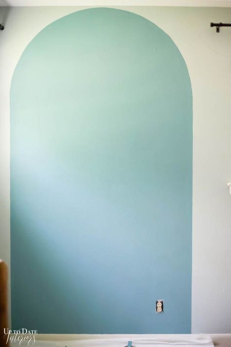 Change your room in an afternoon with a DIY painted arch accent wall and update a piece of furniture in the same color for a big impact! Head over to uptodateinteriors.com to see step by step instructions and video. #sponsored Paint Arches Bedroom, Arched Wall Painting, Arched Wall Paint, Arch Design On Wall, Painted Arch Feature Wall, Painted Arch Accent Wall Nursery, Diy Painted Arch On Wall, How To Paint Arch On Wall, Diy Geometric Wall Paint Patterns