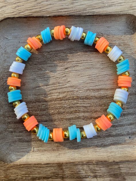 Stretchy bracelet with orange,light blue,and white Clay Bead Bracelet Ideas Fruit, Orange Bangle Bracelet With Colorful Beads, Yellow Bracelet Ideas, Glass Bead Bracelet Ideas, Bracelets Preppy, Make Clay Beads, Bracelet Business, Colorful Bead Bracelets, Clay Bracelets