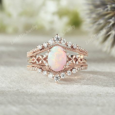 Unique Opal Engagement Ring Set Rose Gold Moissanite Ring Enhancer Moissanite Double Curved Wedding Band Fire Opal Ring Set Bridal Ring Set ◆RING DETAILS: ❃Engagement ring: Centre Stone: Stone: Opal Shape: Oval cut  Size: 6x8mm Side Stone: Moissanite Shape: Round cut Weight: 0.04ct ❃Band Width:1.5mm ❃Wedding band: Stone: Moissanite Shape: Round cut Weight: About 0.388ct Band Width: 5.0mm ◆All ring sizes are available, If you can't find your ring size in the list, please feel free to contact me. Opal Wedding Ring Set, Gold Moissanite Ring, Opal Engagement Ring Set, Rose Gold Moissanite Ring, Unique Opal, Ring Enhancer, Opal Engagement Ring, Opal Wedding Rings, Fire Opal Ring