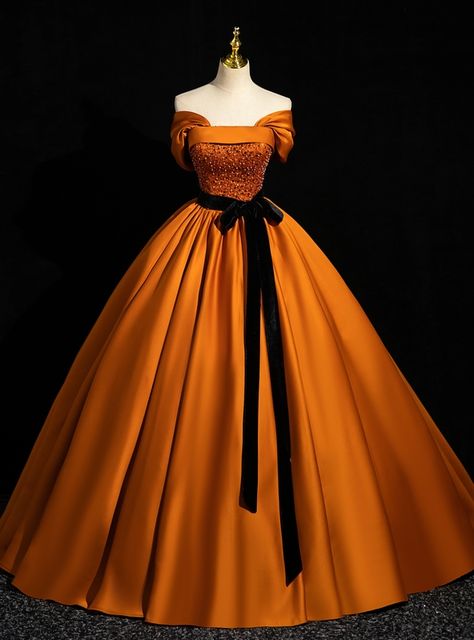 Alive with regal charm, this Quinceanera dress is a masterpiece of design and elegance. The striking orange fabric, paired with a sophisticated off-shoulder neckline, creates a timeless and captivating look. The bodice is adorned with delicate beadwork that glistens with every movement, adding a touch of glamour and sparkle. A black velvet ribbon at the waist enhances the silhouette, providing a perfect balance of boldness and elegance. The full, flowing skirt is made from high-quality materials that ensure a luxurious feel and a graceful drape. Ideal for those who want to stand out, this dress is a perfect blend of classic beauty and contemporary style. Each element, from the intricate beadwork to the sumptuous fabric, has been meticulously crafted to make you feel like a princess on your Black Velvet Ribbon, Junior Prom, White Evening Dress, Exquisite Gowns, Orange Satin, Prom Dresses Gowns, Prom Ball Gown, Red Evening Dress, Quinceanera Dress